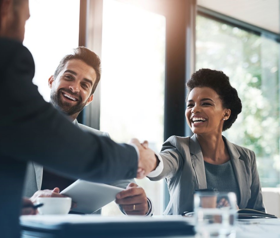 Women shaking a hand of a man